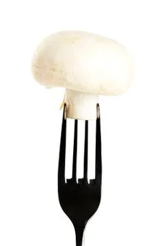 White mushroom on a fork Stock Photos