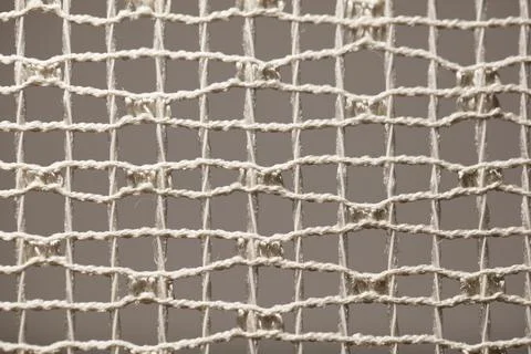 White netting with knotted ropes forms square pattern Stock Photos