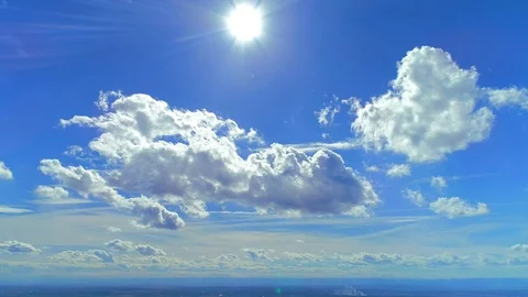 White, nice, soft clouds running across brilliant blue sky. 4K Stock Footage 116888806