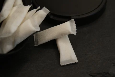 White nicotine pouches with black packaging Stock Photos