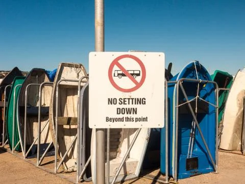 White no setting down beyond this point bus sign marina boats parked holiday  Stock Photos