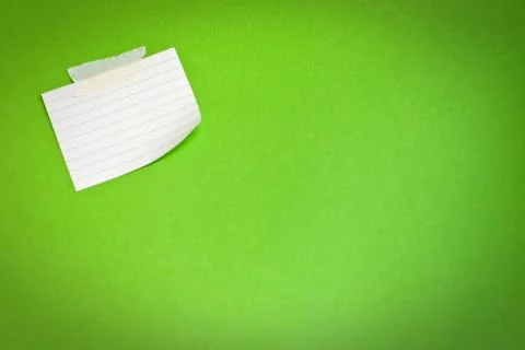 White note paper attached on green background Stock Photos