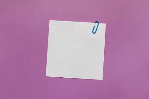 White note paper label with clip on purple background Stock Photos