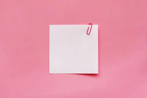 White note paper label with clip on pink background Stock Photos