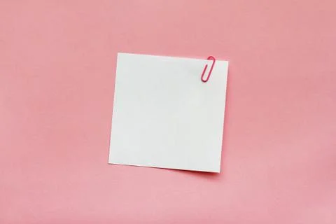 White note papers label with clip on light pink background Stock Photos