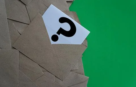 White note in a printed envelope with a question mark icon. Learning concept Stock Photos