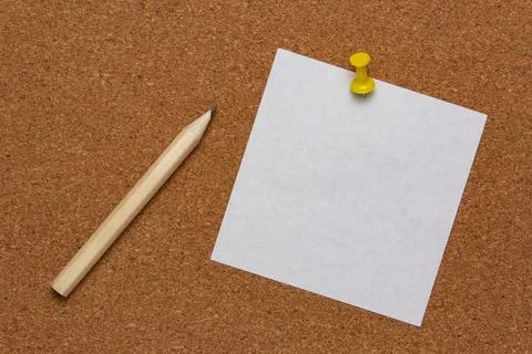 White note sheet pinned on cork board and pencil Stock Photos