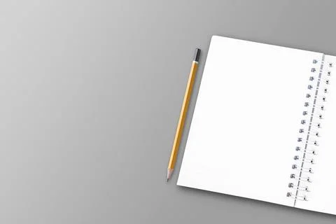 A white notebook and pencil are placed on a white paper surface. Stock Photos