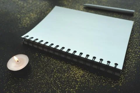 White notebook on black background. Stock Photos