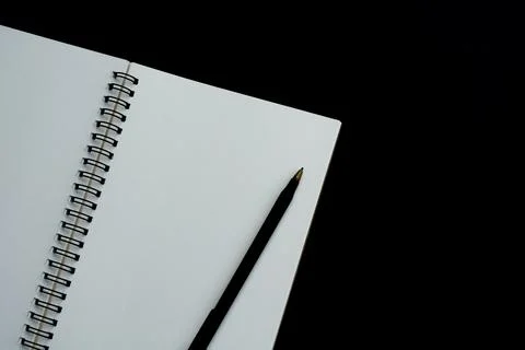 White notebook with dark background. Space for text and top view Stock Photos