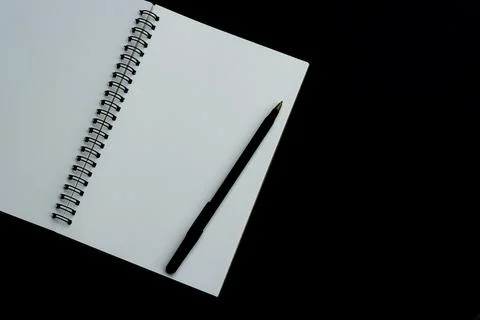 White notebook with dark background. Space for text and top view Stock Photos