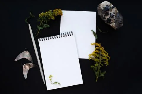 White notebook mockup template on black background with magical mysterious mood. Stock Photos