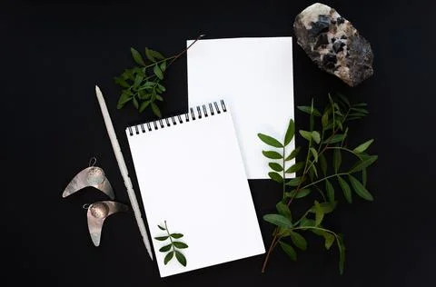 White notebook mockup template on black background with magical mysterious mood. Stock Photos