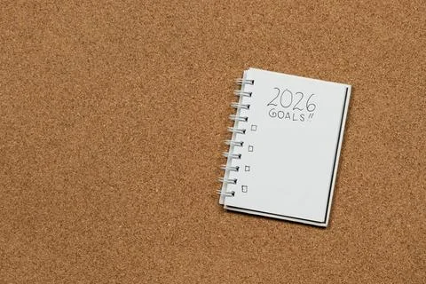 A white notebook at the right side of the screen with 2026 year goals in bl.. 写真素材