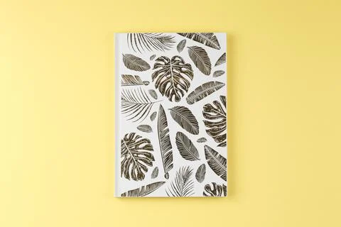 White notepad with gold leaves. Stock Photos