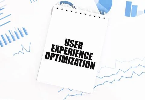 White notepad with text USER EXPERIENCE OPTIMIZATION on the financial docum.. Stockfoto's