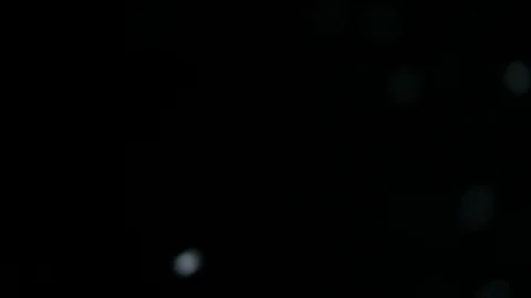 White nowflakes floating in the air on a black background. Stock Footage 96697498