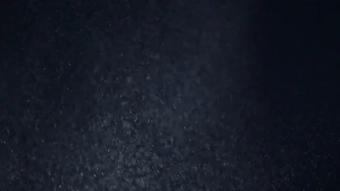 White nowflakes floating in the air on a black background.Ideal for making video Stock Footage 102379144