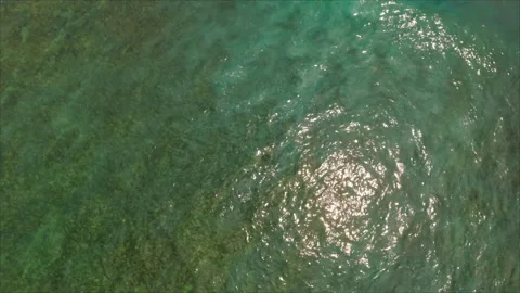White ocean wave moving over turquoise ocean Stock Footage 336575740