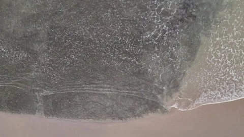 White Ocean Waves Rolling Toward Sandy Beach Under Clear Blue Sky Stock Footage 339822620