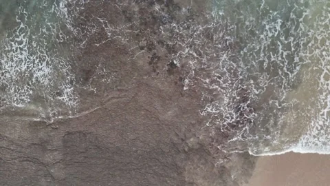 White Ocean Waves Rolling Toward Sandy Beach Under Clear Blue Sky Stock Footage 339822641