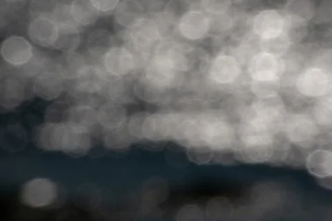 White octagonal bokeh lights sun reflecting in lake water reflections graphic re Stock Photos
