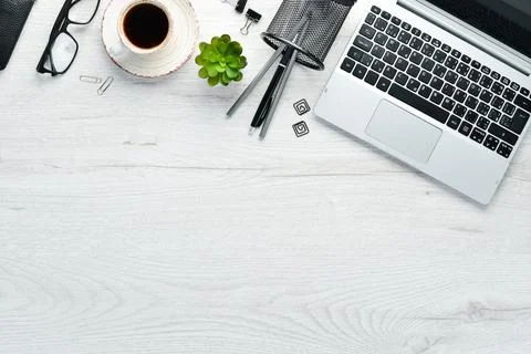 White office desk with blank notebook, computer keyboard and office supplie.. Foto stock