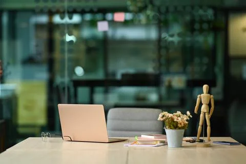 White office desk with laptop computer, glasses, notebooks and flower pot Stock Photos