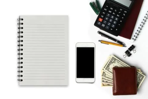 White office desk with smartphone with black screen, pen, wallet, and supplie 스톡 사진
