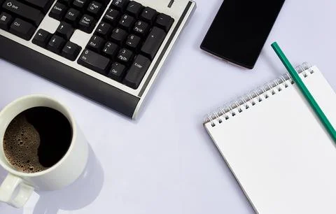 White office desk table with blank, computer keyboard and other office suppli Stock Photos