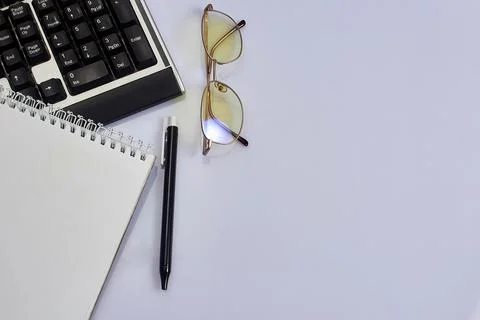White office desk table with blank, computer keyboard and other office suppli Stock Photos