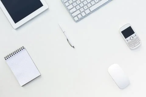 White Office Desk Table with Computer Keyboard  and Other Gadgets and Stationery Stock Photos