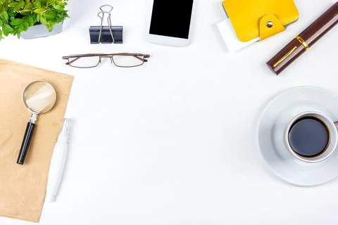 White Office desk table with computer, pen and a cup of coffee, lot of thin.. Foto stock