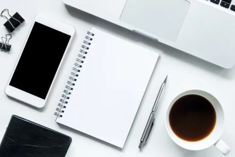 White office desk table with notebook, laptop, coffee and supplies. Top view, Stock Photos