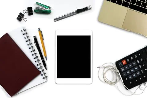 White office desk with tablet computer with black screen, pen, notepad, lapto Foto stock