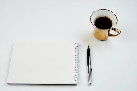 White office Desk top view with Notepad, pen and coffee Cup, minimalistic des Stock Photos