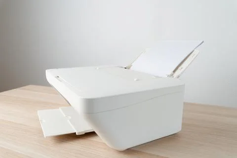White office printer with a stack of blank A4 paper loaded in the feeder tray Stock Photos