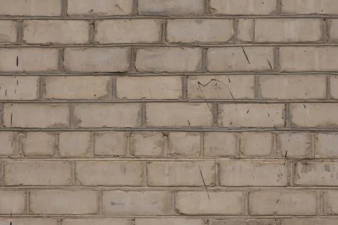 White old brick wall, close-up. The view from the street. Stock Photos
