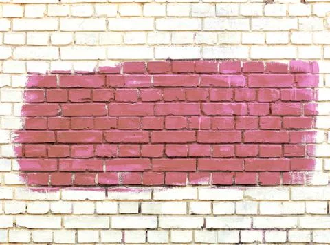 On the white old brick wall the selected fragment is painted with broun paint Stock Photos