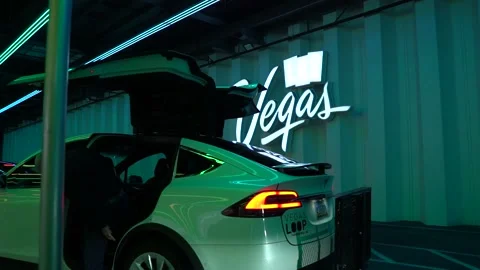 White old men exit White Tesla Model Y at Vegas LVCC Loop. Stock Footage 225537201