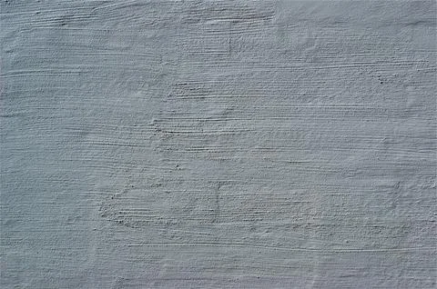 White old plaster on the wall. Decorative plaster structure background. Stock Photos