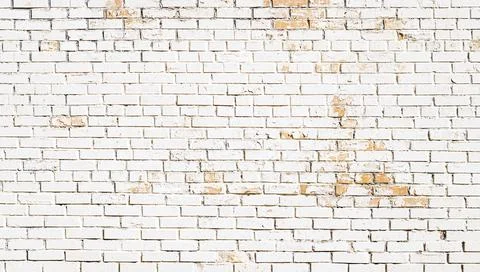 White old scuffed brick wall with cracks background Stock Photos
