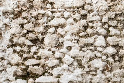 White old stone wall texture with moss. Stock Photos