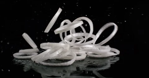White onion rings falling on a black background slow motion. Close up view, shot 動画素材 108654543