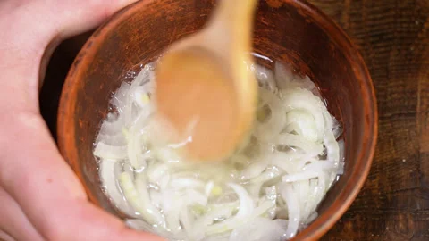 White onion soaked in water to remove bitterness Stock Footage 249880159