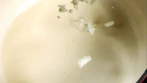 White onions falling into a cooking pot Stock Footage 327178786