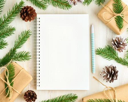 White open notepad, bullet journal and Christmas decoration lying on white Foto stock