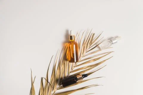 White, orange and black serum bottles on white background. Trending golden Stock Photos