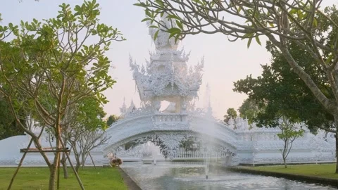 White ornate bridge leading to one of the buildings at White temple complex with Stock Footage 315855533