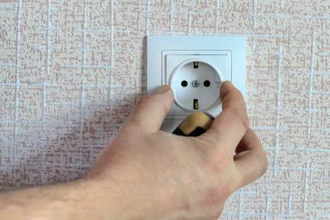 White outlet. the wizard with a screwdriver sets it in place Stock Photos